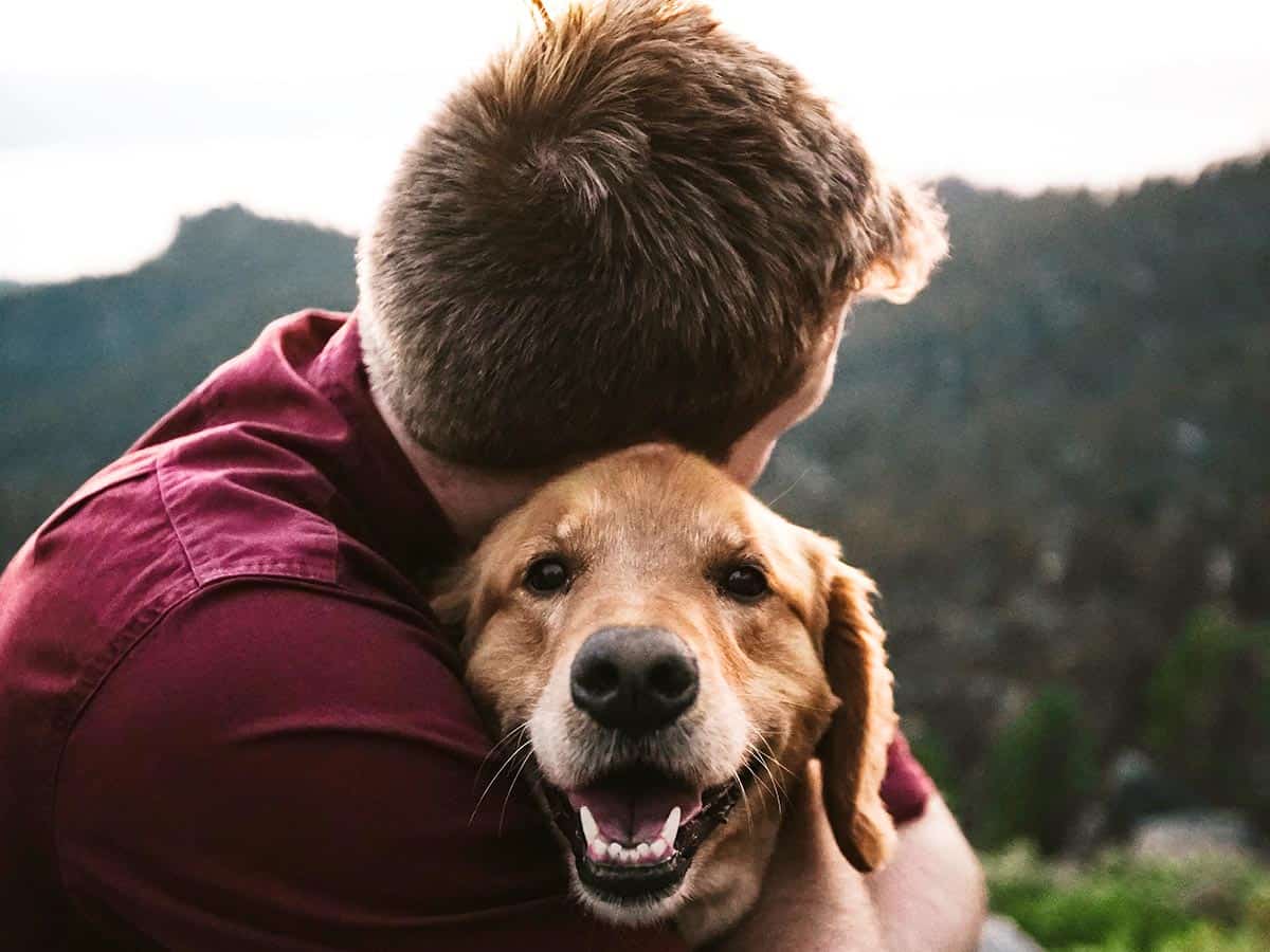 Man hugging dog